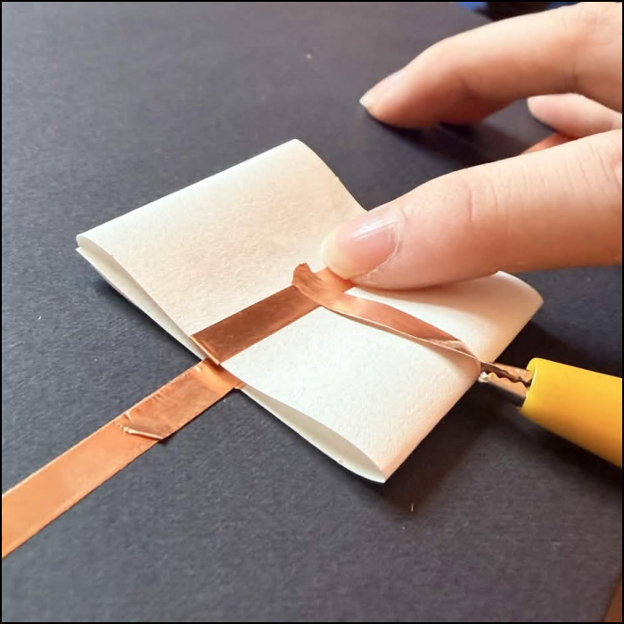 Testing the tape to see if the clamp will rip it or not